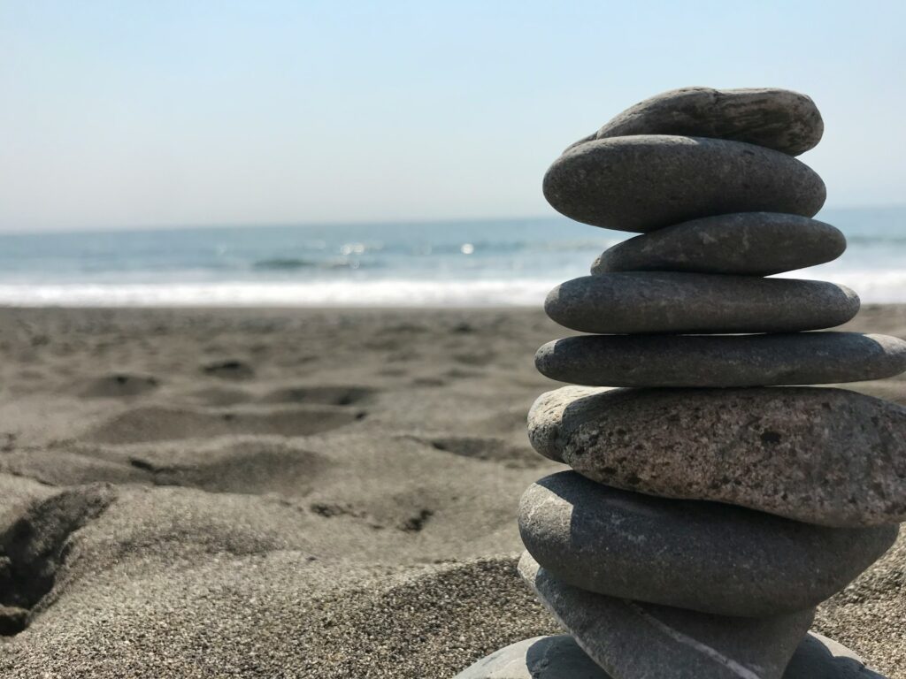 Stack of stones on beach during daytime